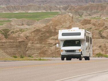 RV-class-C-climbing-scenic-mountain-road-in-the-Badlands-144332861_3872x2592