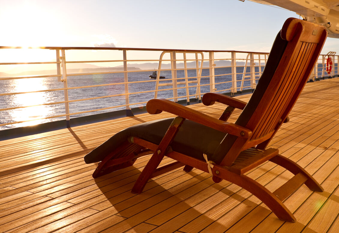 Wooden-lounge-chair-on-the-deck-of-a-cruise-ship-157558621_3867x2578